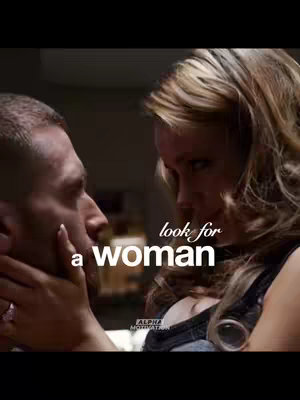 A close-up shot of a man and a woman looking at each other intimately. The man is positioned on the left, his face partially visible in profile, as the woman on the right gazes at him. Overlayed is the text "look for a woman".