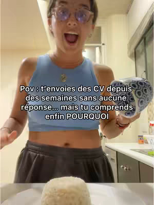 A selfie-style shot featuring a woman looking surprised and holding a ceramic container inside of a kitchen. In foreground, a plate of rice.