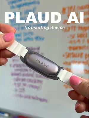 A close-up of a wrist-worn device held between two hands with pink nail polish, text overlayed with 'PLAUD AI translating device', background is blurred whiteboard with writing