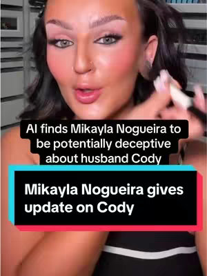 The cover image is a selfie-style shot featuring a woman with a full face of makeup, presented in a vertical orientation. The woman is looking directly at the camera with a moderately neutral expression. Two text overlays are positioned on the image in rectangular bars. The background appears to be a room with some visible elements out of focus.
