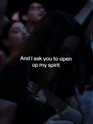 The cover image is a blurred shot with several people in a dimly lit scene, suggestive of a concert or performance. A song lyric is overlaid in white text.