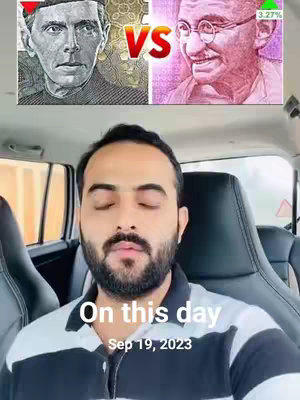 The cover image presents a central composition with a face of a man centered, surrounded by various elements suggesting an 'On This Day' theme. Above the man's head, there are depictions of two personalities with 'VS' in between them. The background shows the interior of a car, creating a personalized setting. A text overlay in white font announces the day's date, increasing the narrative.