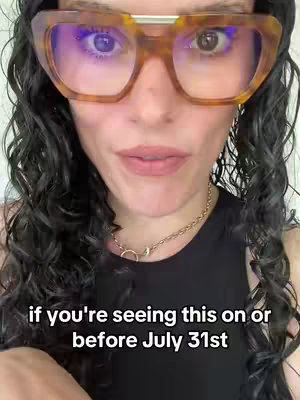 The cover image features a close-up shot of a woman with curly dark hair and large, patterned glasses. She is wearing a black top and a gold chain necklace. The background is a plain white wall. Text overlay at the bottom of the image reads 'if you're seeing this on or before July 31st'.