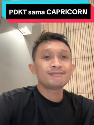 A man with short black hair and a mustache in a black t-shirt is centered in the frame. The title is overlaid at the top with a contrasting background.