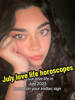 A selfie-style shot featuring a young woman with dark curly hair looking at the camera with a slightly posed expression. She is leaning on her hand, with her chin resting on her fingers. The background is dark. There's text overlayed at the bottom in a slanted yellow box.