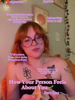 The cover image shows a woman with red hair and glasses in a close-up shot. Text overlays with astrology-related phrases are placed over her. Behind her, a framed picture and wall decor are visible. The woman has tattoos on her upper body and is looking at something off-camera.