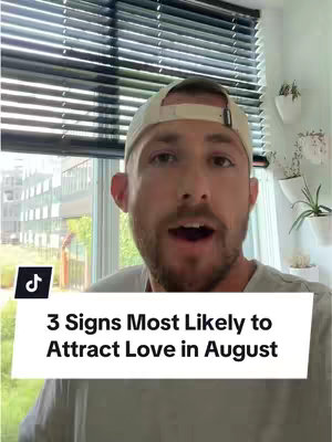 The image captures a man in a light-colored cap and a gray t-shirt in a well-lit room. He is looking directly into the camera with an open mouth, suggesting he is speaking or about to speak. Below him, a white rectangular text box displays the text "3 Signs Most Likely to Attract Love in August" in a bold, sans-serif font. The background shows a window with blinds and partial greenery.