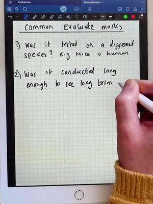 The cover image shows a close-up view of what looks like a digital tablet displaying a grid paper. On the screen, there is handwritten text with the title, 'Common Evaluate marks'. A hand holding a stylus is positioned on the right side of the screen, in the process of writing on the paper. A yellow sweater can be observed from the arm of the creator.