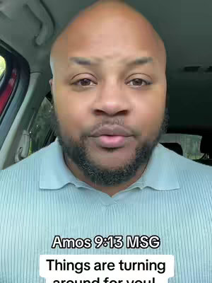 A man with a shaved head and a full beard is shown from the chest up, positioned inside a vehicle. The background reveals the car's interior. Below, superimposed text against a white box displays a quote from Amos 9:13 MSG and a message urging viewers to note changes.