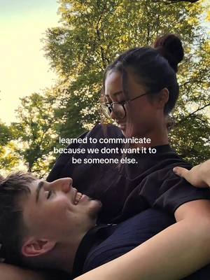 A cover image showing two individuals embracing outdoors, surrounded by trees. The man is lying down looking up smiling, and the woman is leaning over him with a gentle expression, both bathed in natural light. Text overlayed on the image provides extra context.