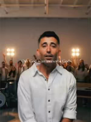 The cover image shows a man in a white shirt singing with joy in a large room. Overlaid on the image is the text 'Our God is an awesome God'. Behind the man, a crowd of people are singing and clapping with lights in the background.
