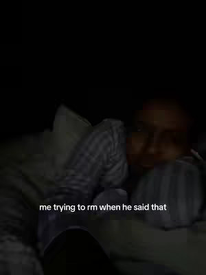 The cover image shows a dark, somewhat blurry interior, likely a bedroom. A person is lying down on a bed with a striped top, with a pillow visible. Text overlayed on the bottom, 'me trying to rm when he said that'.