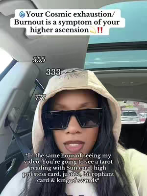 A woman with dark hair and sunglasses is seated in a car. The cover image has overlay text at the top, some numbers placed down the sides of the woman's face, and text at the bottom.