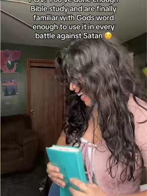 The cover image presents a woman holding a teal book while indoors. She is positioned slightly off-center, with her face visible in profile, showing a smile. The background appears to be a domestic setting with indistinct details, the lighting is natural and the overall composition suggests a candid moment. Text overlayed highlights the video's theme.