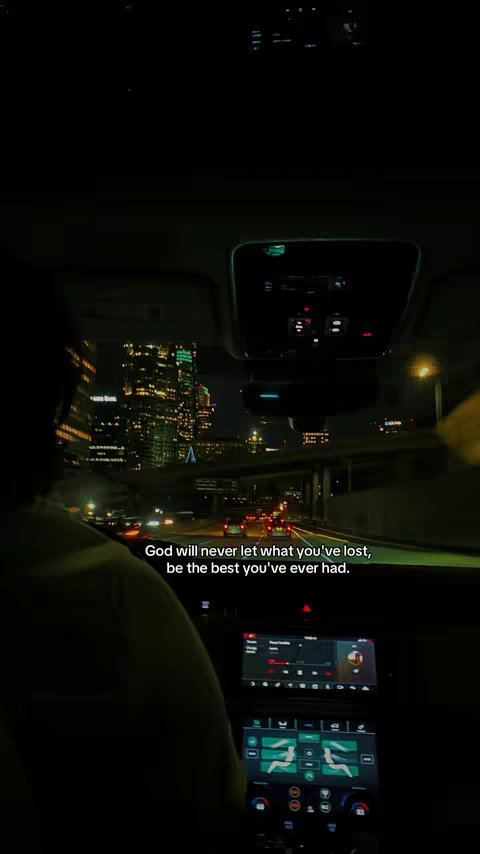 The image shows the interior of a car at night, with a city skyline visible through the windshield. The car's dashboard and a portion of the driver are in the foreground. Text is overlaid on the image, conveying a motivational message.