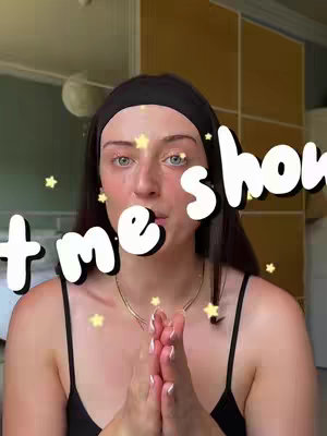 The cover image presents a close-up of a woman's face against a light background, framed in a vertical orientation. She is looking directly at the camera with an expression of anticipation or excitement. The main focal point is her face, with text overlays featuring the words "time show" in white with a black borderline. Additional decorative elements include yellow star graphics scattered around the text and the woman's face. She is wearing a black headband and a black top, with her hands clasped in front of her in a pose that suggests supplication or expectation, and a thin necklace.