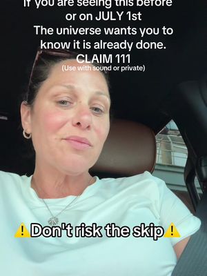 A woman with brown hair, wearing a white t-shirt, is seated inside a vehicle. The top caption contains text related to the current date; the bottom text serves as a hook to encourage engagement by commenting on the post.
