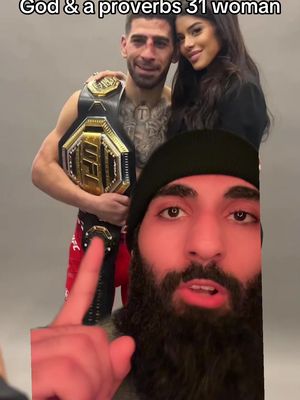 The image is a vertical selfie-style shot. In the foreground, a man with a dark beard and a black beanie points at the camera. Behind him is another scene of a well-dressed man with a belt and a woman looking at the camera. The overlay text says 'God & a proverbs 31 woman'. The image is in the typical, portrait format of social media.