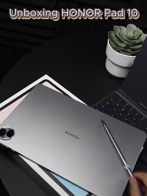 The cover image shows a gray tablet with the word "HONOR" visible, a stylus, a white box, a keyboard, and a small green plant. The tablet is the main focus, positioned at an angle on a dark surface. Text overlayed reads "Unboxing HONOR Pad 10."