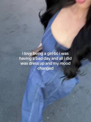 The image shows a woman in a denim dress angled from an upward perspective. It has text overlaying the image about dress up and mood.