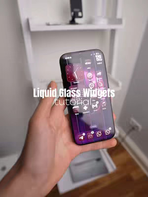 A hand holding a phone displaying a custom home screen with transparent widgets. The background features a white shelf and a wall. Text overlays describe the widgets.