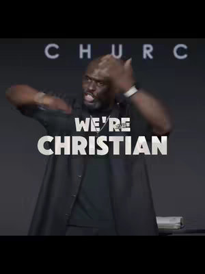 The image shows a man speaking to what seems like a crowd or his audience. The word "CHURCH" is faintly visible at the top. The man in the image is a Black male with short hair and a beard. He is wearing a black shirt and appears enthusiastic. The text overlay is in white and is slightly transparent.