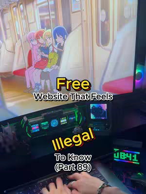 The cover image shows a computer screen displaying what appears to be an animated scene of several anime-style girls on a train, the screen is positioned above a desk with a keyboard and computer monitors, with the text overlayed providing context.