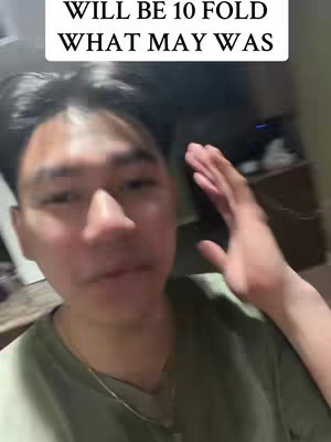A young man in a green shirt looking at the camera, with text overlayed at the top. He's got dark hair and is gesturing with his right hand, as if making a point. The background is slightly out of focus, appearing to be an indoor setting.