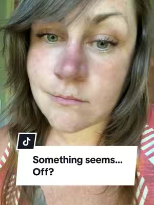 A close-up shot of a woman's face, angled slightly to the side, with a concerned expression. She has fair skin and green eyes. A text overlay in a white box near the bottom reads "Something seems... Off?" The background is blurred, suggesting an indoor setting. The bottom right corner has a tiktok logo.