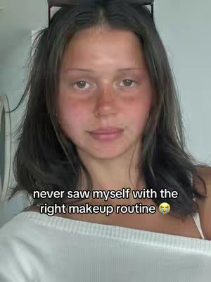 A selfie-style shot featuring a young woman with dark hair, upper body visible. She is positioned centrally, with neutral expression and looking at the camera. The background is plain and lightly colored. Text overlay is featured at the bottom, emphasizing the content.