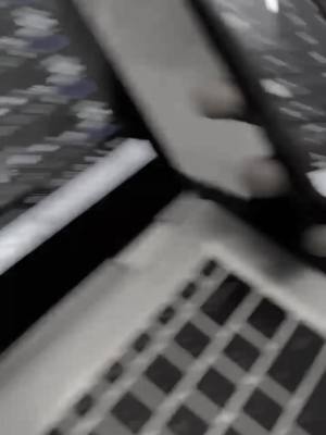 A slightly blurred overhead shot of a laptop keyboard and a portion of an adjacent surface with a textured pattern. The keyboard is the dominant element, showing the tops of the keys arranged in a grid, with the surrounding area appearing out of focus.