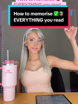 A woman with long, light-colored hair is seated at a desk with a pink cup, and a digital notepad. An overlay text box with the title, 'How to memorise EVERYTHING you read'. She is wearing glasses and a light-colored dress, and smiling.