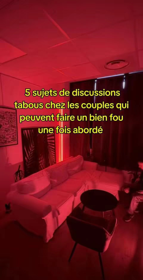The image shows a modern living room with a white sofa, a black table, and a dark chair. Text overlays are present promoting a discussion on taboo subjects for couples.