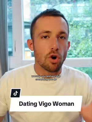 A man with short brown hair and a white t-shirt is centered in the frame. He is speaking with his mouth open, against a bright window background. Text overlays at the bottom read 'Dating Virgo Woman' and in a smaller font at the top 'worship you and worship everything you do', with a TikTok logo on the bottom left.