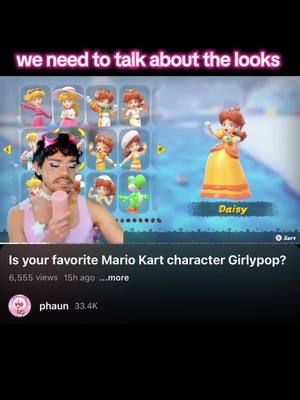 The image is a screenshot from a video with a pink and blue color scheme. The top portion shows the words 'we need to talk about the looks' in white. A person with makeup is holding a pink object resembling a microphone. To the right, there is a game screen featuring a Daisy character from Mario Kart and character selection screens. At the bottom, there is video information including a title, view count, and the creator's name.
