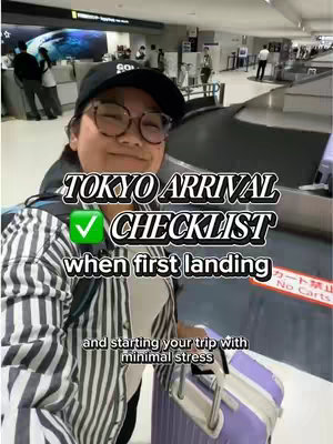 A selfie shot in an airport setting. A person wearing glasses, a black baseball cap, and a striped shirt smiling at the camera, holding a purple suitcase. Overlaid text reads 'TOKYO ARRIVAL CHECKLIST'.