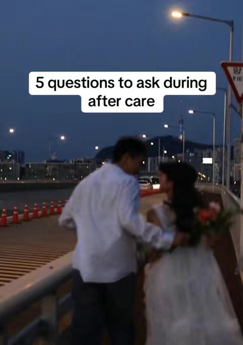 An evening shot on a bridge with streetlights. A couple is walking with the man in a white shirt leading. Text over the image reads, '5 questions to ask during after care'. The sky is dusk.
