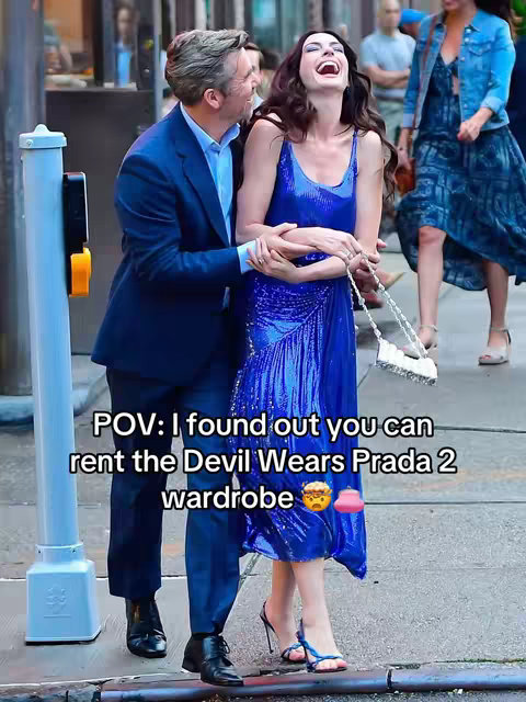 A cover image shows actress Anne Hathaway laughing and embraced by a man on a city street. They are both dressed in stylish clothes, and other people stand in the background. The text overlay reads 'POV: I found out you can rent the Devil Wears Prada 2 wardrobe'.