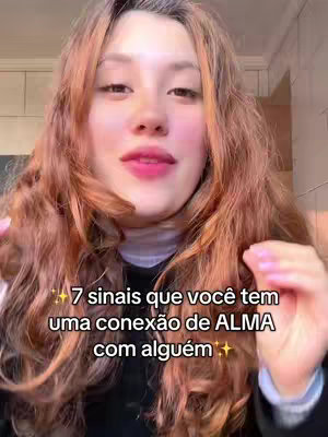 A woman with long, wavy auburn hair looks directly at the camera. She has light skin, pink lipstick, and is wearing a black top with a white turtleneck underneath. Text overlayed on the image reads the video's topic.