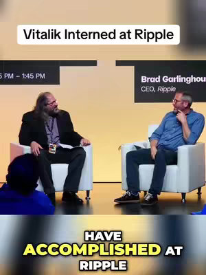 A panel discussion with two men seated in white chairs on a stage. Text overlays indicate the topic relates to Vitalik Buterin and Ripple, and the text "HAVE ACCOMPLISHED AT RIPPLE" appears at the bottom. The background is a gradient of yellow and orange.