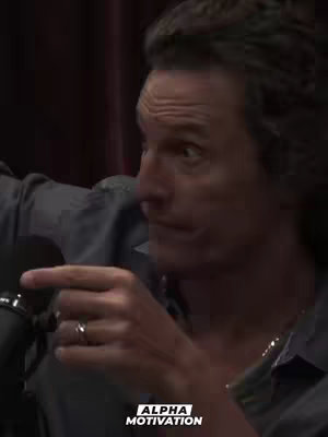 The cover image features a close-up shot of a man with medium-length hair, wearing a gray shirt. He is pointing his finger and has a ring on his finger. The background is a dark, blurry red. The overall composition is focused on the man's expression and gesture.