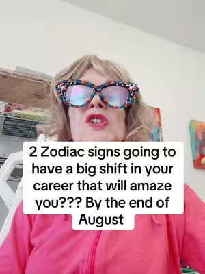 A woman with blonde hair and large, decorative glasses looks directly at the camera. She is wearing a bright pink zip-up jacket, and there is text overlayed about career shifts and zodiac signs.