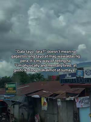 The image captures an overcast sky above a slightly dilapidated cityscape. Text overlays the sky area, conveying a message about needing a break or outing with friends. The photograph incorporates various signs and building structures, suggesting a commercial or residential environment. The overall composition is somewhat somber, with the gray sky setting the tone.