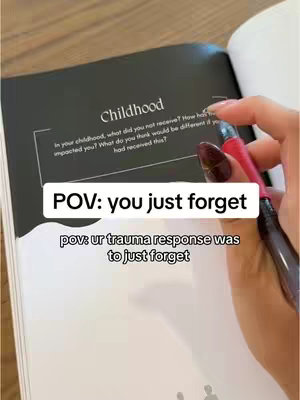 A close-up shot showing a person's hand with long nails holding a pen over an open journal in a white background. The journal, with black pages, is partially visible, displaying the word "Childhood" and a prompt "In your childhood, what did you not receive?" and more text. A white text box with the words "POV: you just forget" and another text below it appears overlayed on the image.