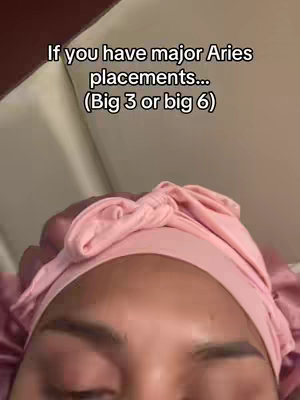 The image shows a close-up of a person's head, with the focus on the forehead and eyes. The person appears to be wearing a pink satin head covering. Text overlays the image.