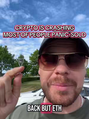A selfie-style shot featuring a man in sunglasses, the background out of focus, with overlay text discussing crypto. He holds a small, heart-shaped object, possibly a charm.