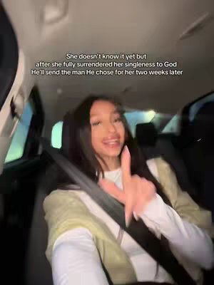 A young woman is seated inside a car, with a seatbelt across her chest. The image is well-lit, suggesting outdoor daylight. Text overlayed on the image provides context to the video.