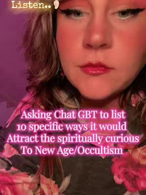 A close-up shot focuses on a woman's face. She has light skin, with red blush on her cheeks and red lipstick. Her eyes are a light color, and she has black eyeliner. The background is a gradient of pink and purple. Text overlays are on the image.
