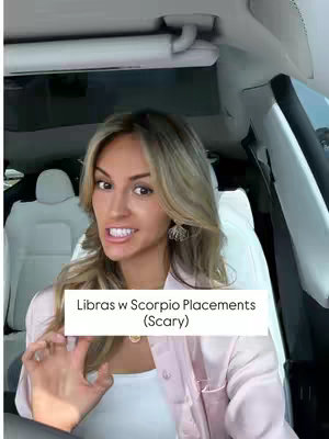 A woman with blonde hair is in the driver's seat of a car, looking at the camera with a slightly concerned or intense expression. She's wearing a light pink shirt. A white box with black text is overlaid on the image.