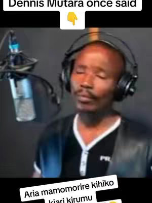 A man with a shaved head is seated behind a microphone, wearing headphones. He's in a recording studio setting. Text overlays indicating who's speaking are included.